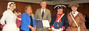 Pictured with Wheeling Mayor Glenn F. Elliott, Jr. are (l to r) Jessica and Emily Keller of Fort Henry Days Living History, Debi Smith, regent, Wheeling Chapter DAR, Jay Frey, president, Fort Henry Chapter SAR, Gary Timmons, member Fort Henry Chapter